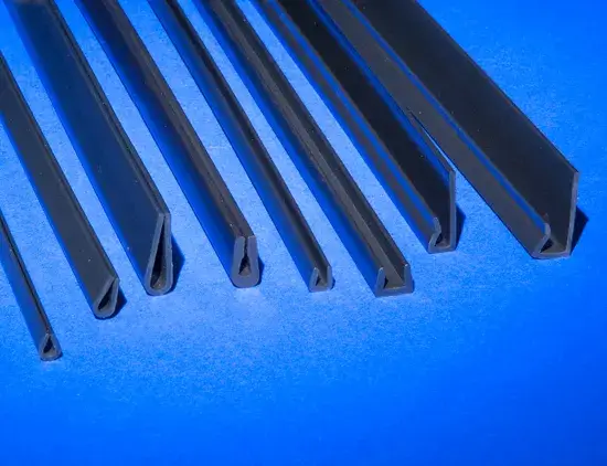 8 different types of Nyla-Glide GR stock plastic profile shapes resting on a blue background 8 different types of Nyla-Glide GR stock plastic profile shapes resting on a blue background